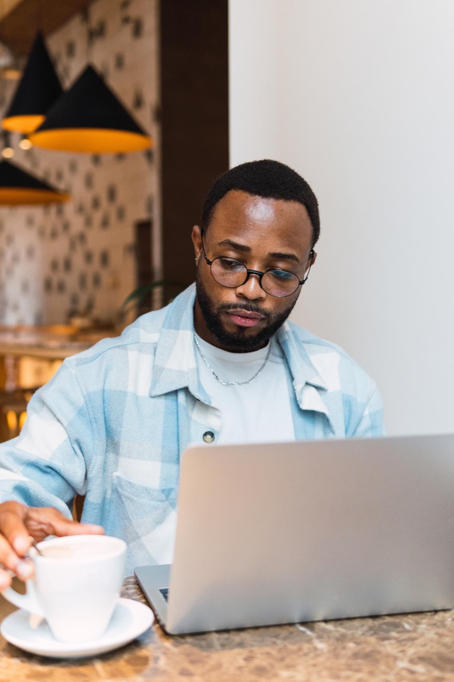 A freelancer working on a laptop in a café